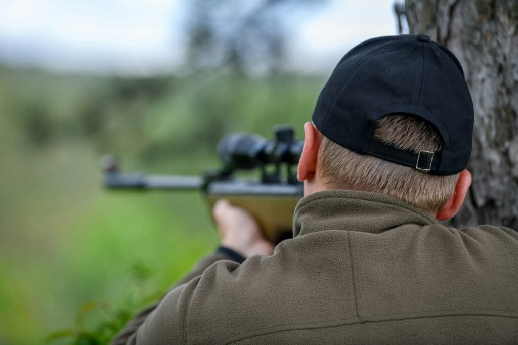 Male with a gun in hunting period